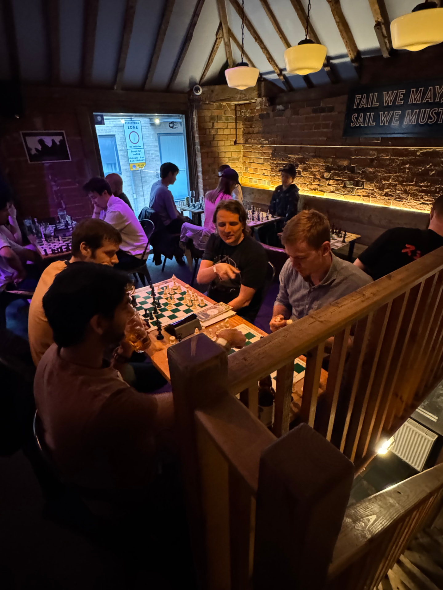 Players gathered around chess boards at a Social Chess evening in Reading